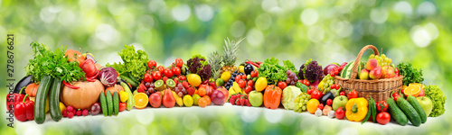 Ripe vegetables and fruits on natural green background