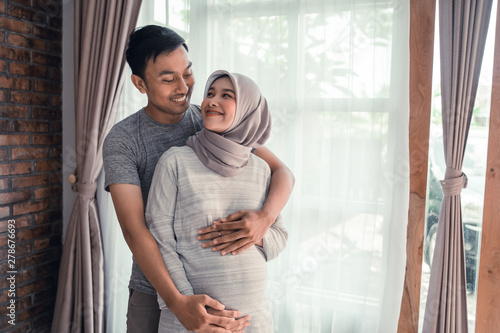 pregnancy muslim woman. happy asian romantic couple expecting baby © Odua Images