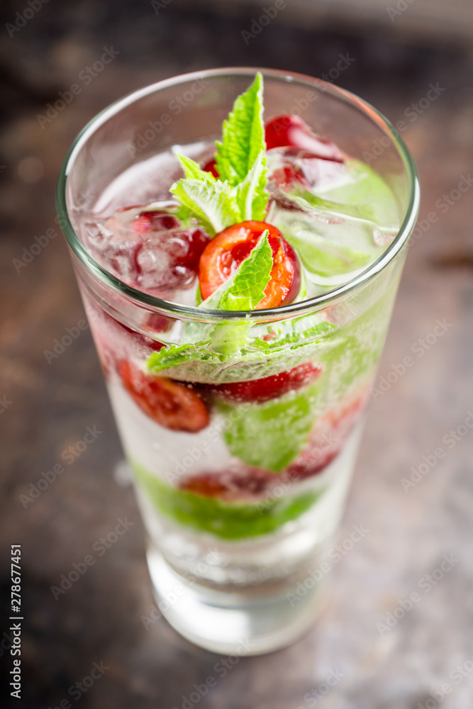 Cherry mojito cocktail on the rustic background. Selective focus. Shallow depth of field. Cherry mojito cocktail on the rustic background. Selective focus. Shallow depth of field.