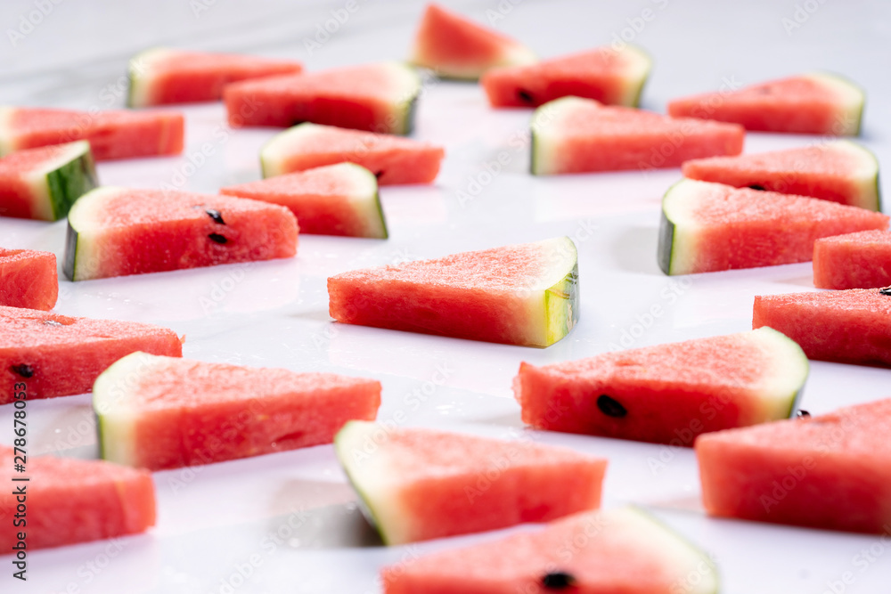 Slices of fresh watermelon on white marble background Slices of fresh watermelon on white marble background