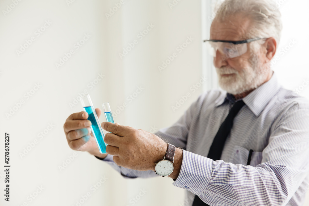 senior professional professor scientist holding and looking at chemical tube with difference medical formula and compare result in science research laboratory senior professional professor scientist holding and looking at chemical tube with difference medical formula and compare result in science research laboratory