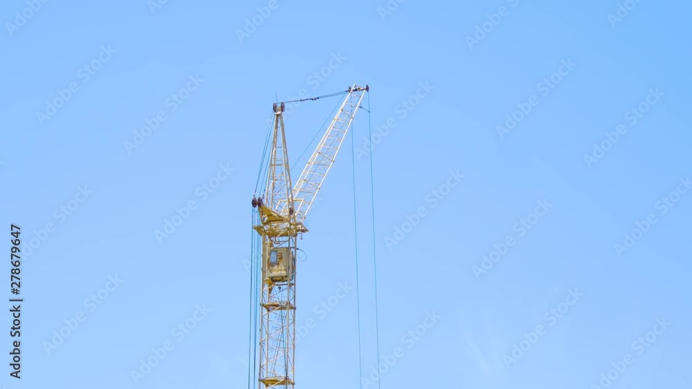 Work building crane close-up against the blue sky. Infrastructure and construction. Work building crane close-up against the blue sky. Infrastructure and construction.