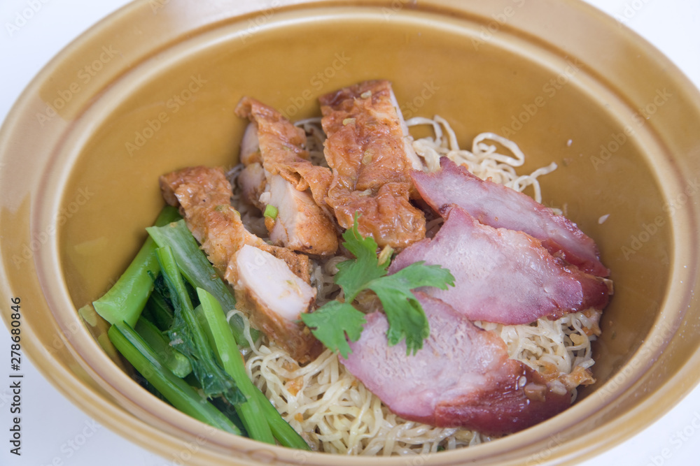 Dried egg noodles with roasted pork and fried chicken. Dried egg noodles with roasted pork and fried chicken.