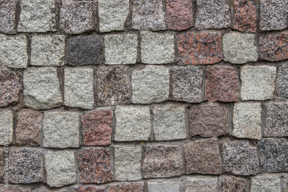 Obraz premium Gray building stone for paving walls and roads. Texture, background, paving stone