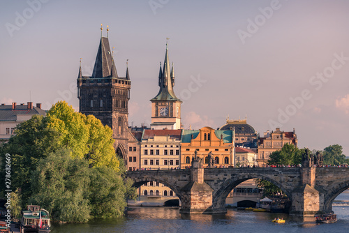 Prague landmarks of Bridge Tower and Charles bridge at golden hour