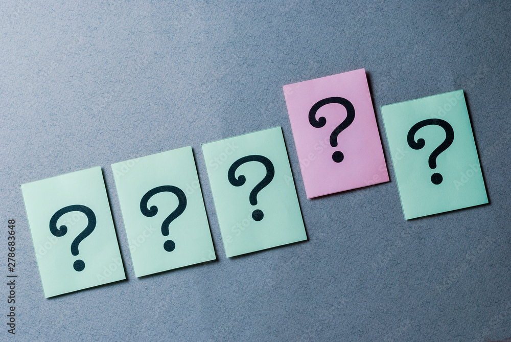Line of four green question marks and one pink Line of four green question marks and one pink