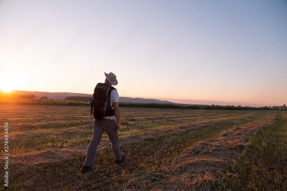 backpacker traveler walking at sunrise