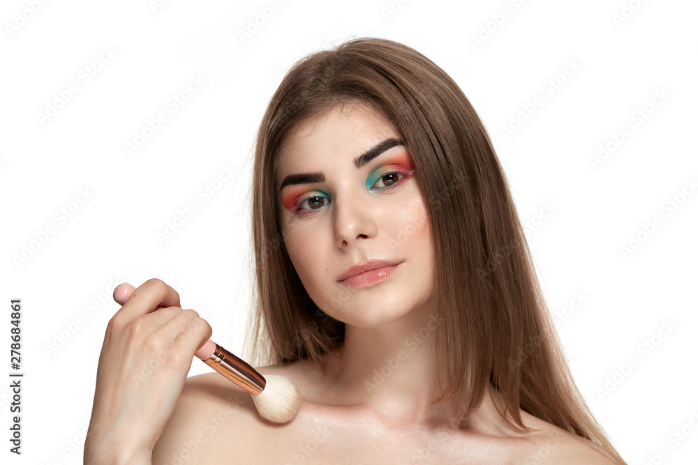 Closeup portrait of beautiful young woman with brushes for make-up Closeup portrait of beautiful young woman with brushes for make-up