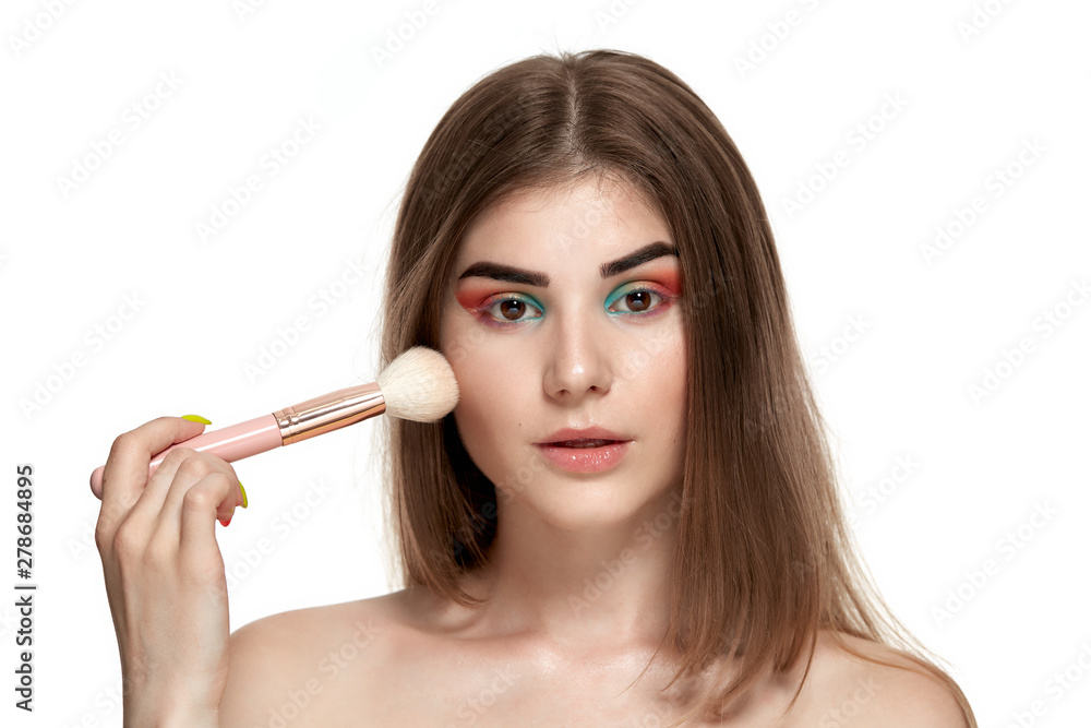 Closeup portrait of beautiful young woman with brushes for make-up Closeup portrait of beautiful young woman with brushes for make-up