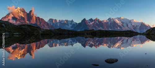 Panorama of the Mont Blanc massif reflected in Lac de Chesery during sunset. Chamonix, France. photo