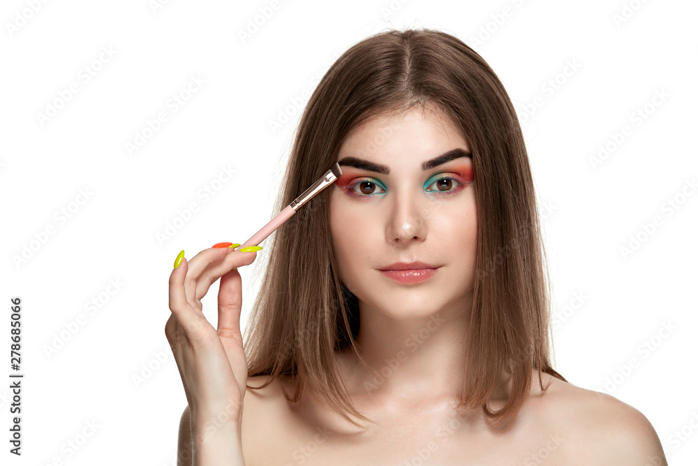 Closeup portrait of beautiful young woman with brushes for make-up Closeup portrait of beautiful young woman with brushes for make-up