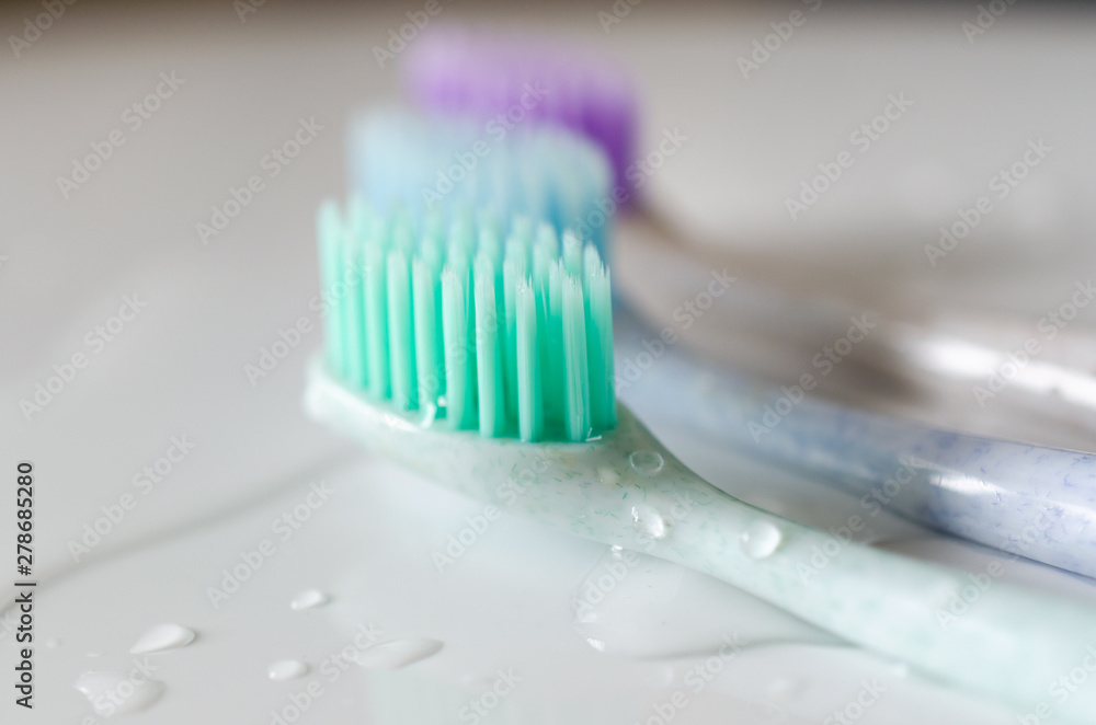 three toothbrushes of different colors on white background. three toothbrushes of different colors on white background.