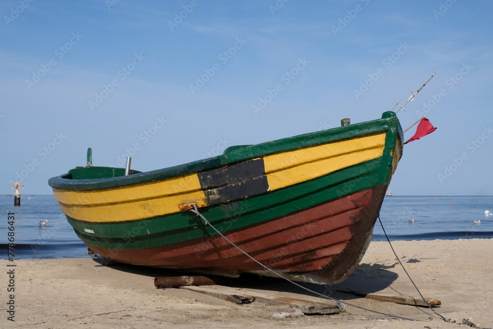 Wooden fishing boat on the beach of Baltic Sea in Sopot/Poland in sunny summer day. 