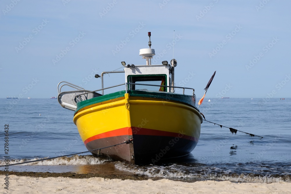 Wooden fishing boat on the beach of Baltic Sea in Sopot/Poland in sunny summer day. 