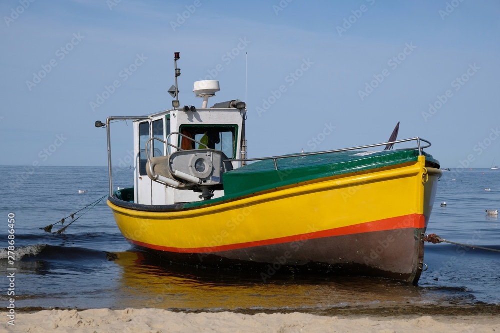 Wooden fishing boat on the beach of Baltic Sea in Sopot/Poland in sunny summer day. 