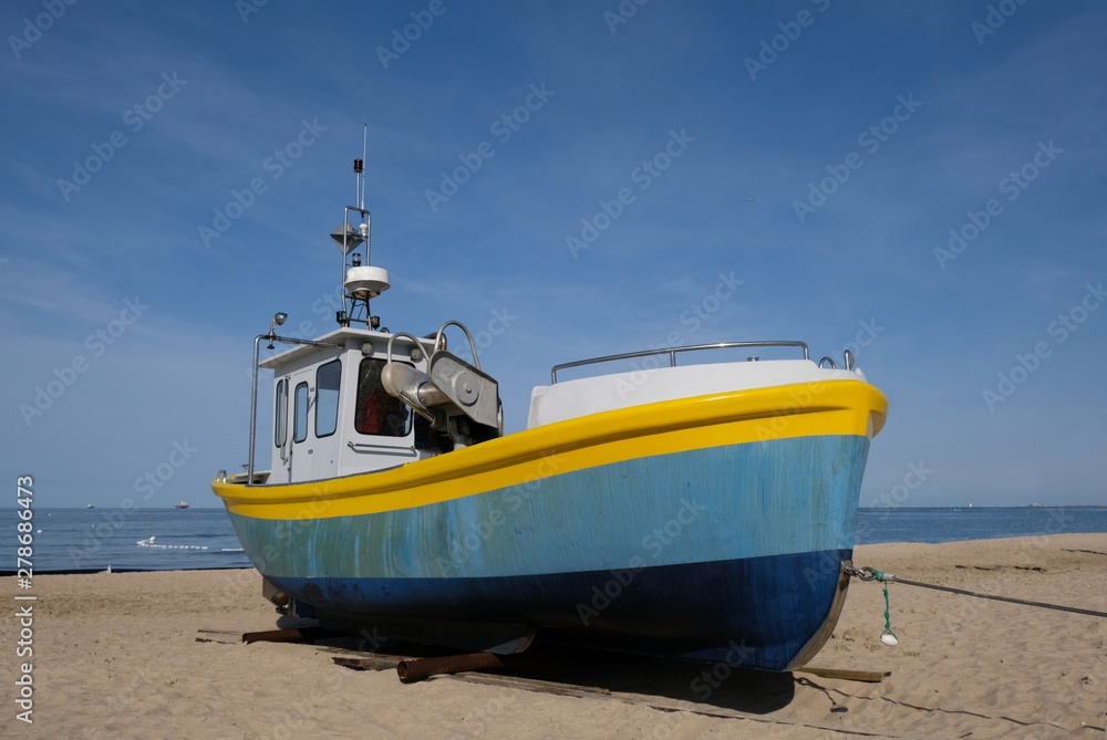 Wooden fishing boat on the beach of Baltic Sea in Sopot/Poland in sunny summer day. Wooden fishing boat on the beach of Baltic Sea in Sopot/Poland in sunny summer day.