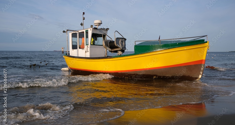 Wooden fishing boat on the beach of Baltic Sea in Sopot/Poland in sunny summer day. Wooden fishing boat on the beach of Baltic Sea in Sopot/Poland in sunny summer day.
