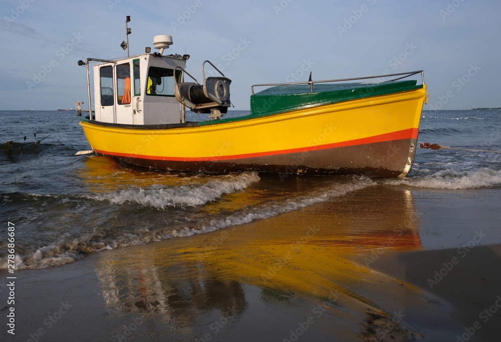 Wooden fishing boat on the beach of Baltic Sea in Sopot/Poland in sunny summer day. 