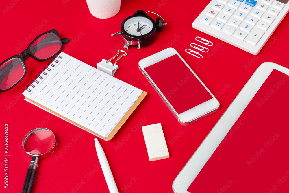 Red office desk table with blank notebook, keyboard and supplies. Top view with copy space. Flat lay. Red office desk table with blank notebook, keyboard and supplies. Top view with copy space. Flat lay.