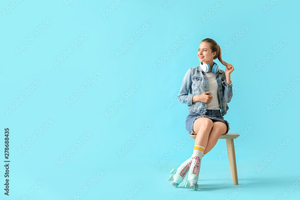 Beautiful young woman on roller skates against color background Beautiful young woman on roller skates against color background