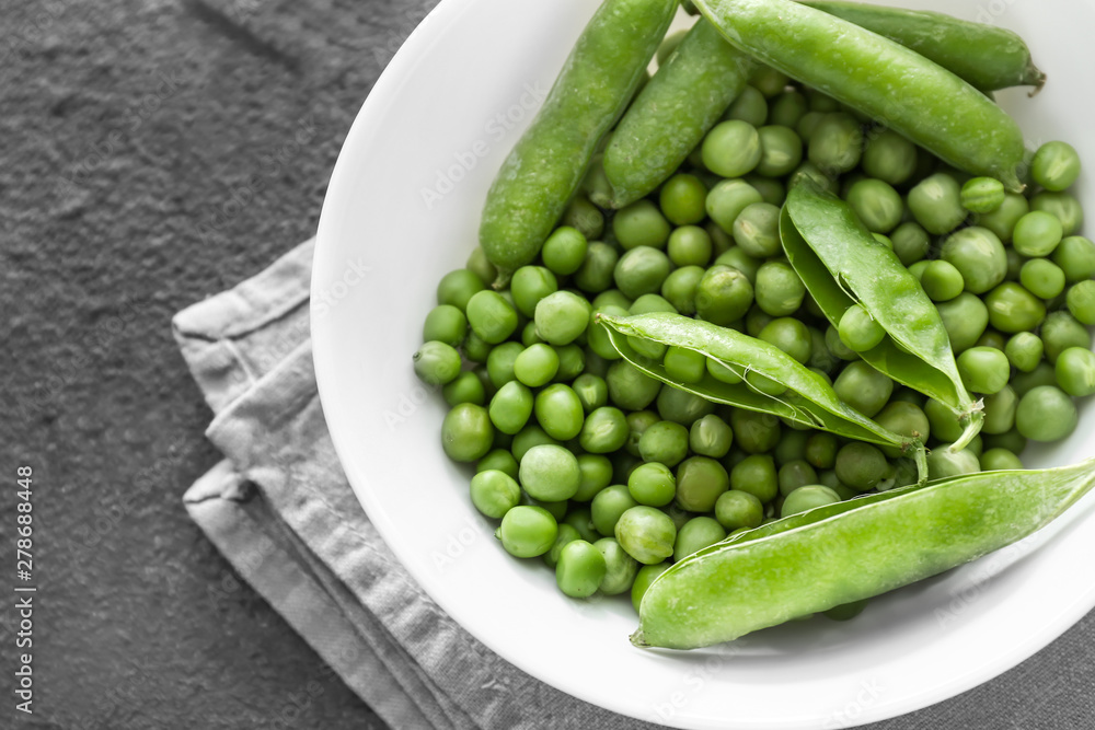 Bowl with tasty fresh peas on dark background Bowl with tasty fresh peas on dark background
