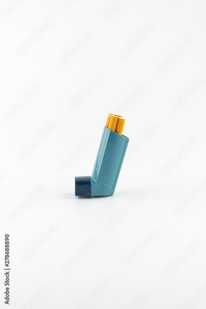 Salbutamol inhaler with cigarettes on white background ( Asthma is not compatible with tobacco) Salbutamol inhaler with cigarettes on white background ( Asthma is not compatible with tobacco)