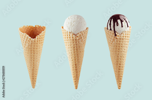 Set of different ice cream cones in waffle cone - empty, white ice cream, with chocolate sauce on green background.
