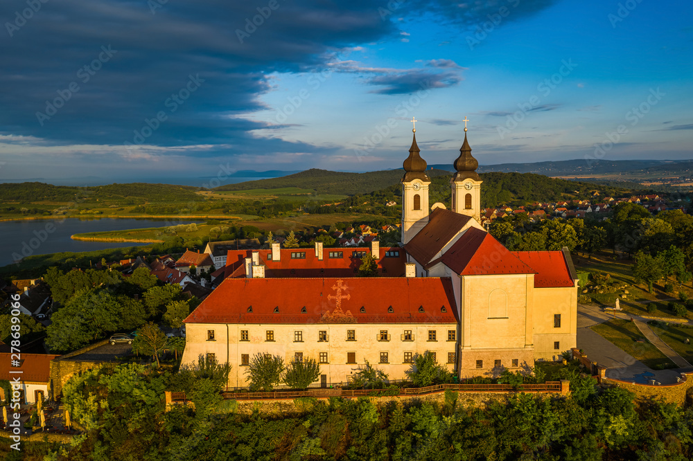 Tihany, Hungary - Aerial view of the famous Benedictine Monastery of Tihany (Tihany Abbey) with beautiful warm sunrise and blue sky over Lake Balaton