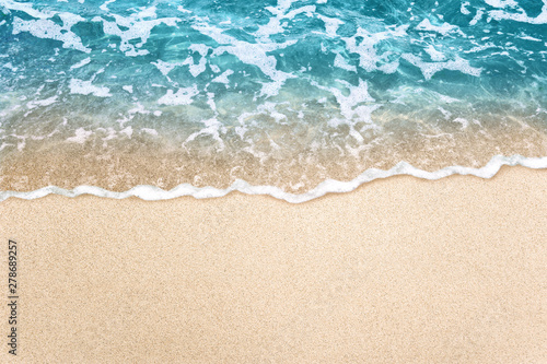 Soft blue ocean wave on clean sandy beach background © OHishi_Foto