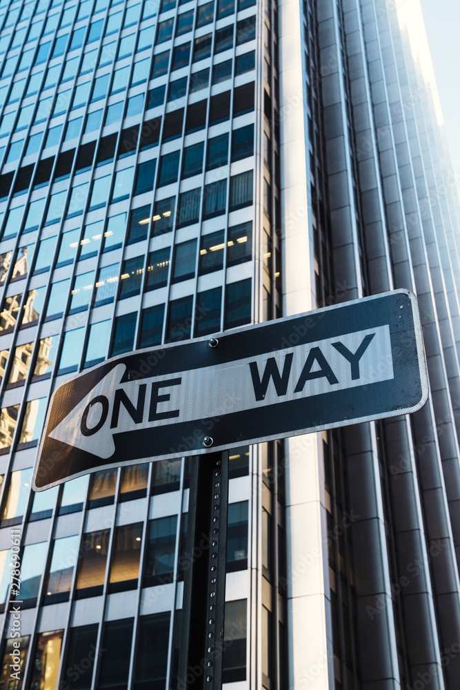 Road sign One way on building background Road sign One way on building background