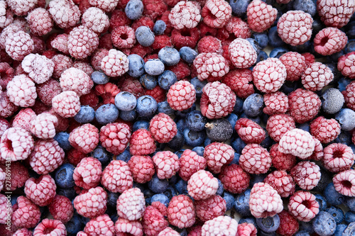 Background of frozen berries. Top view of raspberries and blueberries.