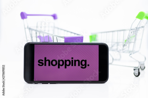 Shopping Cart and smart phone , image use for retail business online for support of customer on internet, marketing business concept.