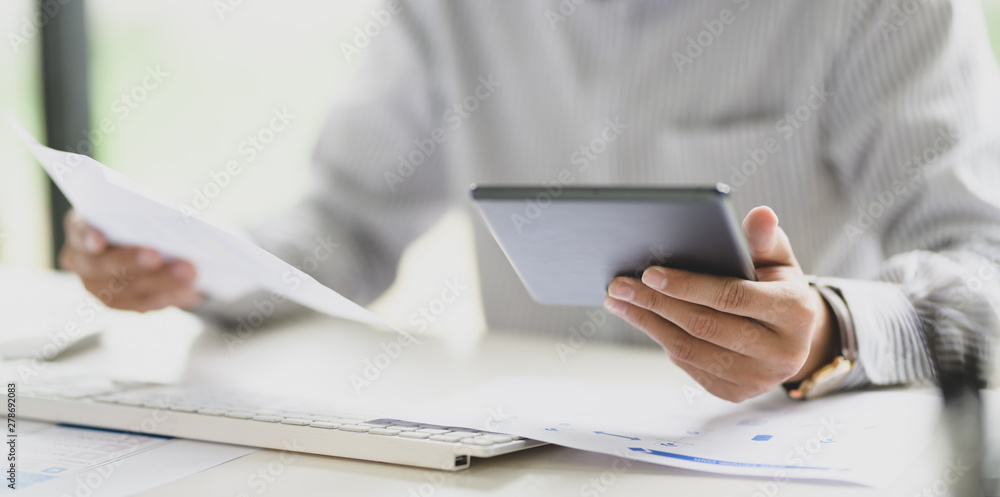 Young businessman working with digital tablet computer ,hands close up Young businessman working with digital tablet computer ,hands close up