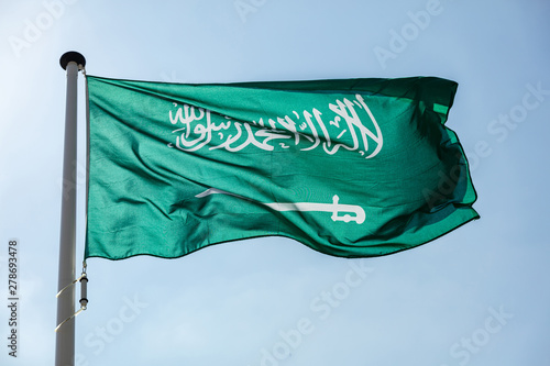 Obraz na plátně Saudi Arabian flag waving against clear blue sky