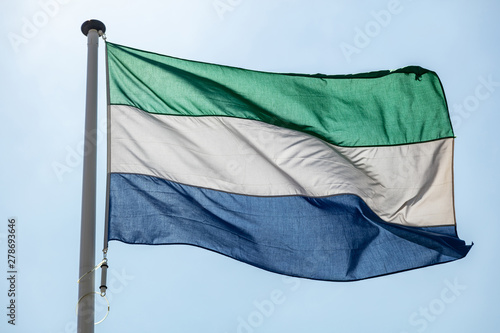 Sierra Leone flag waving against clear blue sky