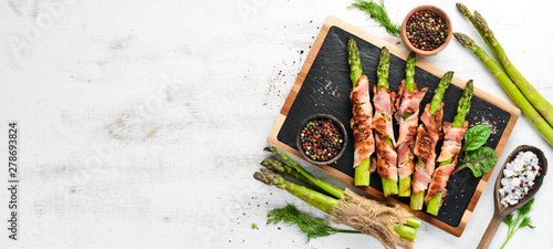 Asparagus baked with bacon and spices. Healthy food. Top view. Free space for your text.