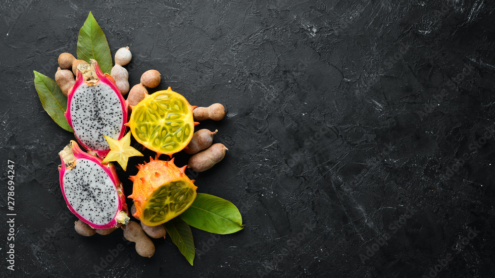 Kiwano and dragon fruit. Tropical Fruits. Top view. Free space for text. Kiwano and dragon fruit. Tropical Fruits. Top view. Free space for text.