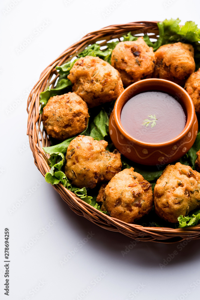 rava Bhajj or bhajiya also known as suji Pakoda or semolina Pakora, served with tomato ketchup. selective focus rava Bhajj or bhajiya also known as suji Pakoda or semolina Pakora, served with tomato ketchup. selective focus
