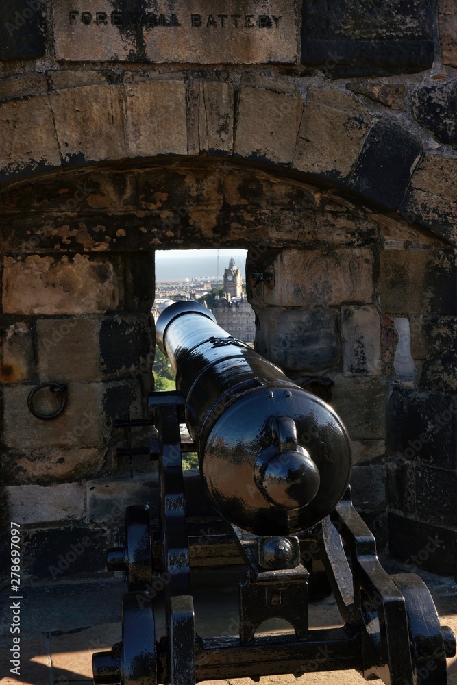 Edinburgh Castle, an old cannon on the carriage at the loopholes, through which a panorama of the city opens. Edinburgh, Scotland Edinburgh Castle, an old cannon on the carriage at the loopholes, through which a panorama of the city opens. Edinburgh, Scotland