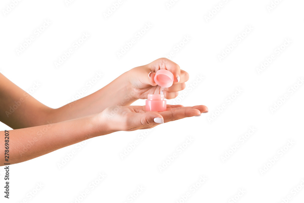 Female hand holding cream bottle of lotion isolated. Girl opening jar cosmetic products on white background Female hand holding cream bottle of lotion isolated. Girl opening jar cosmetic products on white background