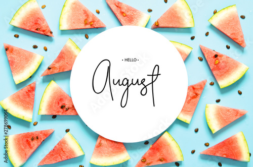 Inscription Hello August. Fresh red watermelon slice Isolated light blue background. Top view, Flat lay. - Image photo