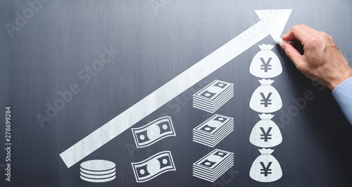 Saving and growing money concept. Businessman drawing money and arrow on chalkboard. Saving and growing money concept. Businessman drawing money and arrow on chalkboard. photo