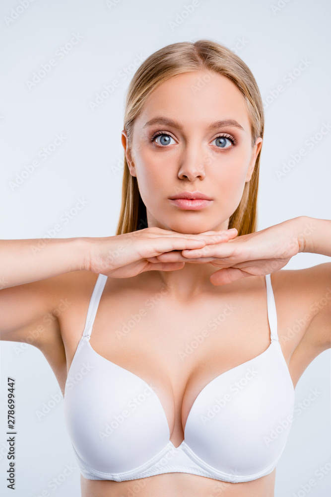 Vertical portrait of nice cute lovely winsome delicate attractive serious  blonde girl wearing bra touching chin isolated over light gray background  Stock Photo