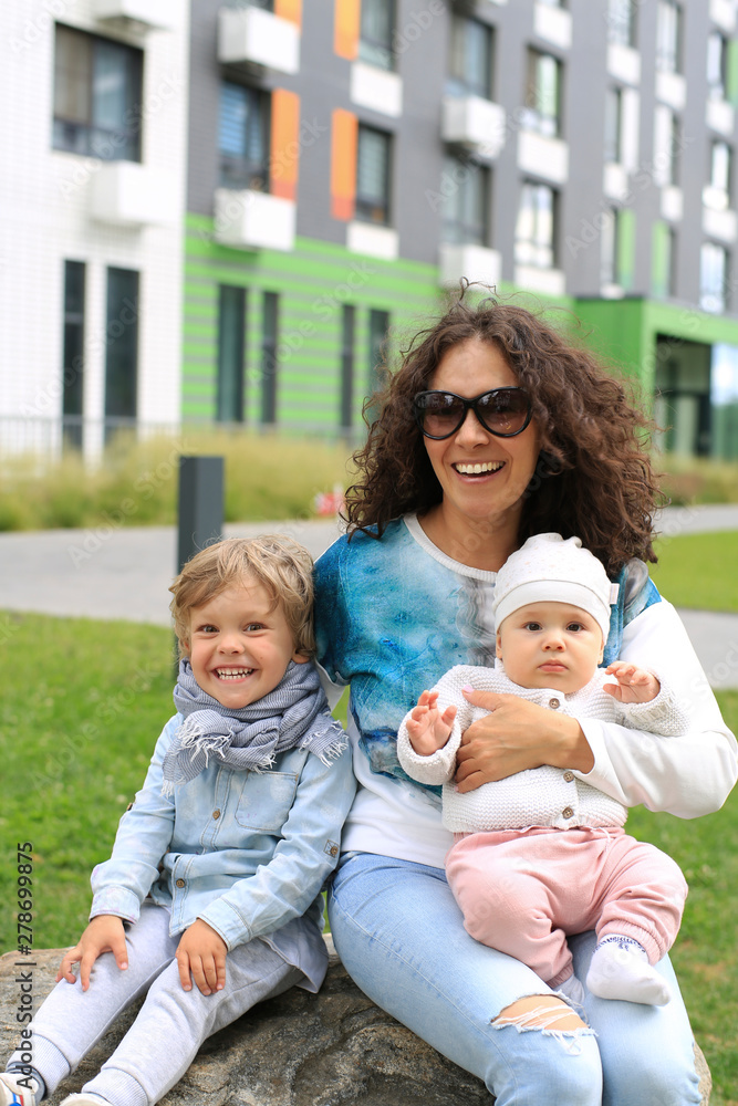 Obraz premium Beautiful and happy mother with two sons