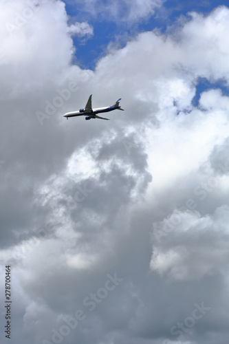 Big aircraft of russian airline Aeroflot flies in the sky in cloudy weather. Moscow, Russia