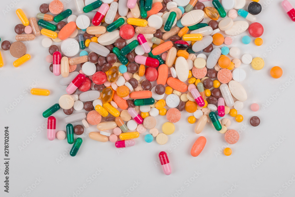High number of pills on white background surface. High resolution image for pharmaceutical industry. High number of pills on white background surface. High resolution image for pharmaceutical industry.