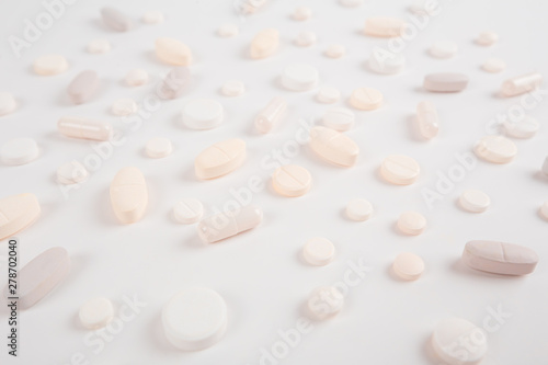 High number of pills on white background surface. High resolution image for pharmaceutical industry.