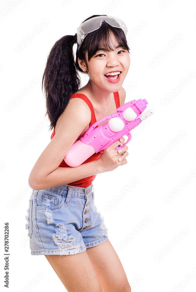 Asian enjoying young woman with gun for playing splashing water in songkran festival ,studio portrait Asian enjoying young woman with gun for playing splashing water in songkran festival ,studio portrait