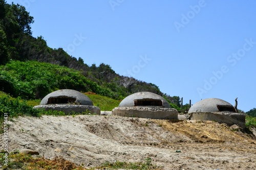 Three military bunkers from Enver Hoxha's dictatorship near the beach at Cape of Rodon in Albania. Cape of Rodon (or Cape of Skanderbeg), Albania