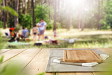 Table background and wooden board and happy people in the forest